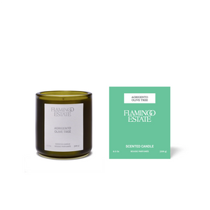 Green candle and packaging with 'Flamingo Estate' branding on a white background