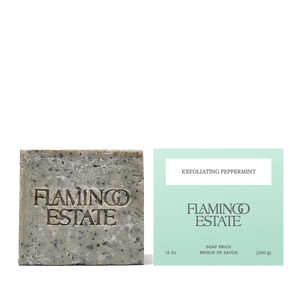 Bar of soap and its packaging with 'Flamingo Estate' branding on a white background