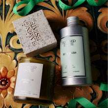 Flaming Estate body wash, candle, and soap on a decorative tile background