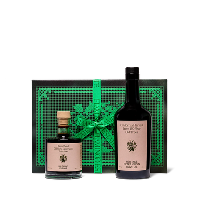 Olive oil and vinegar bottles with a decorative green box on a white background