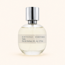 Perfume bottle with metal cap on white background