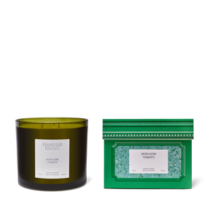 Green candle and packaging with 'Flamingo Estate' branding on a white background