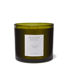Green candle with a label on a white background