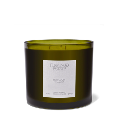 Green candle with a label on a white background