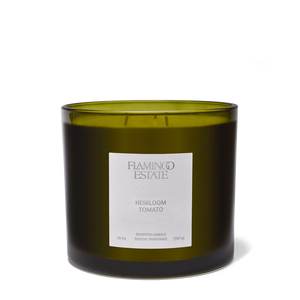Green candle with a label on a white background