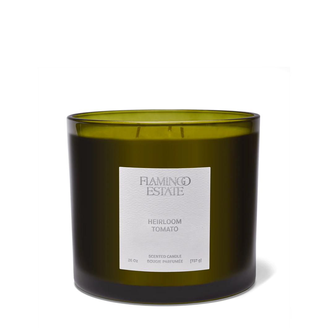 Green candle with a label on a white background