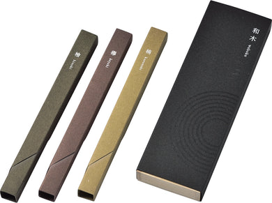 Set of three different incense boxes and a black packaging box with circular pattern on a white background.