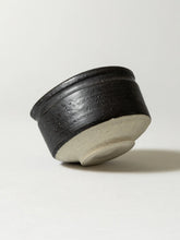 Black ceramic bowl on a white background