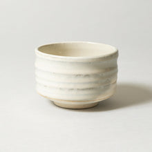 White ceramic bowl on a light gray background