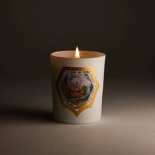 Candle with decorative label on a dark background