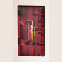 Red chocolate bar packaging with text on a beige background