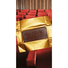 Chocolate bar with gold wrapper labeled 'C.BB' in a theater setting