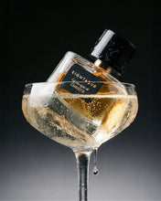 Perfume bottle labeled 'Eight & Bob' in a glass container filled with liquid.