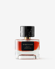 Eight & Bob Perfume bottle with black cap and red label on a white background