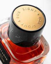 Close-up of a bottle cap with 'EIGHT & BOB' branding on a white background