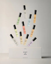 Collection of small perfume bottles with visible 'Eight & Bob' branding on a light gray background.