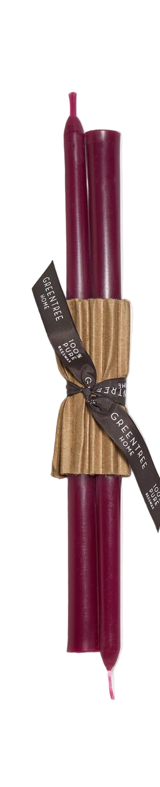 Set of two candles in wild plum color with brown paper wrapping and ribbon on a white background