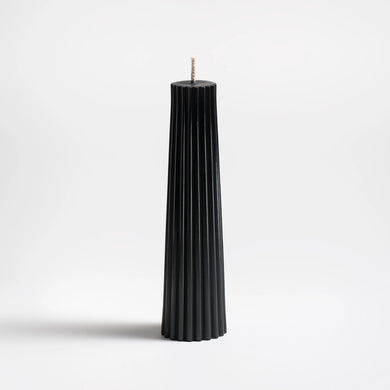 Black pleated candle on a white background