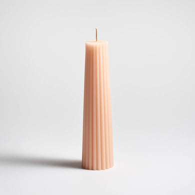 Blush textured candle on a light gray background
