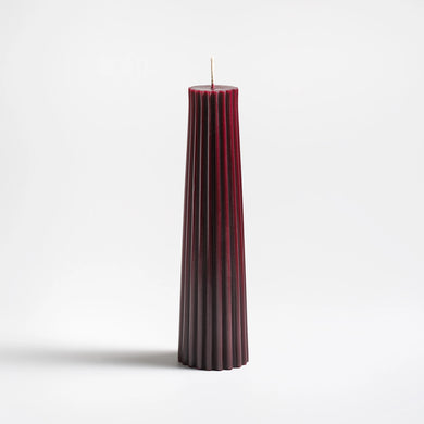 wild plum pleated candle on a white background
