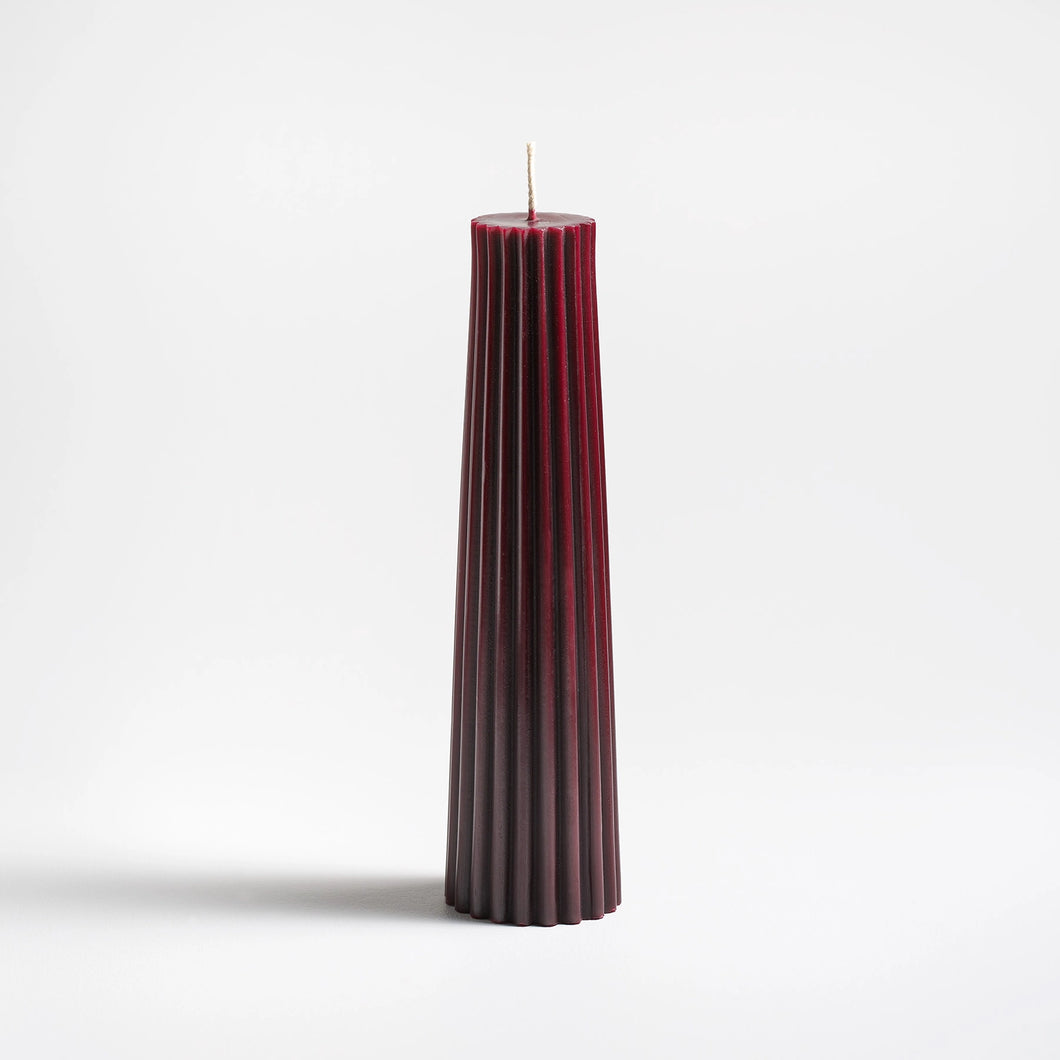 wild plum pleated candle on a white background