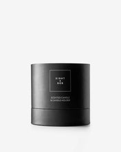 Black candle with 'Eight & Bob' branding on a white background