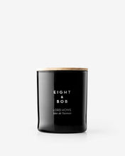 Black candle with 'Eight & Bob' branding on a white background