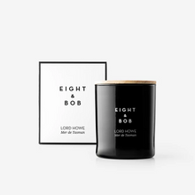 Black candle with 'Eight & Bob' branding on a white background