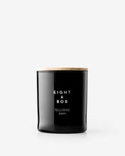 Black candle with 'Eight & Bob' branding on a white background