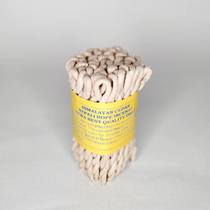 Nepali Himalayan Cedar Rope Incense bundle wrapped in yellow package paper.