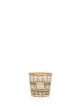 Decorative candle in a glass holder with intricate design on a white background