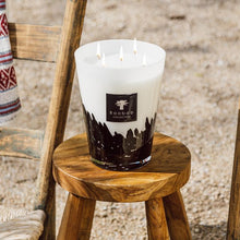 Candle on a wooden stool with a rustic background