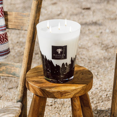 Candle on a wooden stool with a rustic background