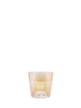 Decorative candle in a glass holder on a white background
