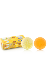 Two yellow bath soaps and their packaging on a white background