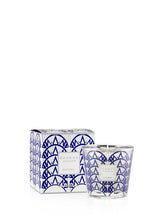 Candle with blue geometric design and packaging on a white background