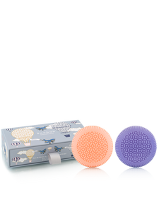 Two soaps, one orange and one purple, with a packaging box featuring illustrations on a white background.