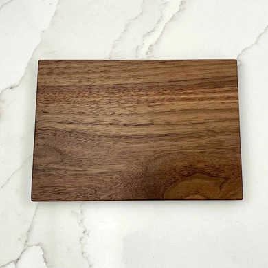 Walnut cutting board on marble counter