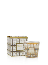 Decorative candle with matching box featuring architectural design on a white background