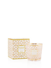 Candle with decorative packaging on a white background
