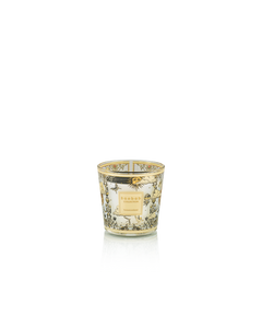 Decorative candle in a glass holder with intricate design on a white background