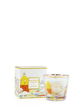 Decorative candle with matching packaging on a white background