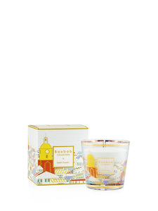 Decorative candle with matching packaging on a white background