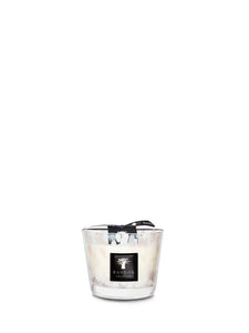Candle in a glass holder with a black label on a white background