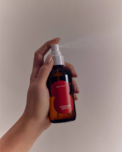 hand holding a room spray bottle