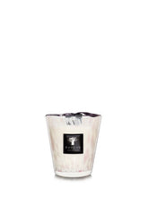 Candle in a glass holder with a visible brand label on a white background