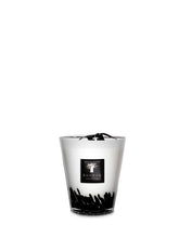 Clear glass candle with black base and logo on a white background
