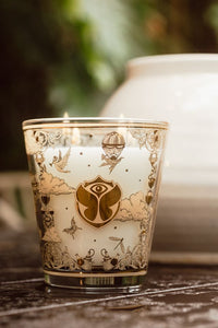 Decorative candle with intricate gold designs on a wooden surface