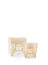 Candle in a decorative box with geometric patterns on a white background