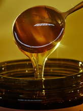 Spoon drizzling honey